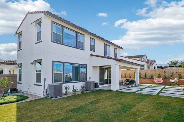 an aerial view of a building with garden space and ocean view
