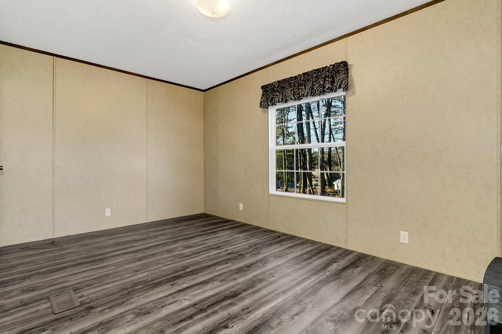 44 Tuttle Road Hendersonville, NC 28792 - Photo 36 of 37 a view of an empty room with wooden floor and a window
