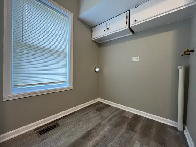 a view of a room with rack and wooden floor
