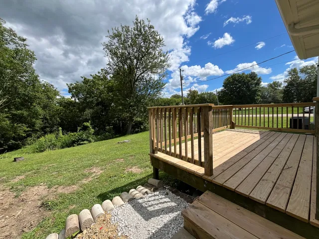 a view of a backyard with swimming pool