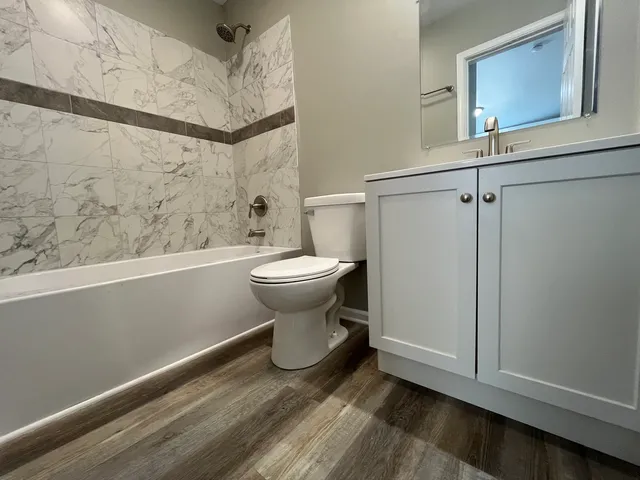 a bathroom with a toilet and a shower
