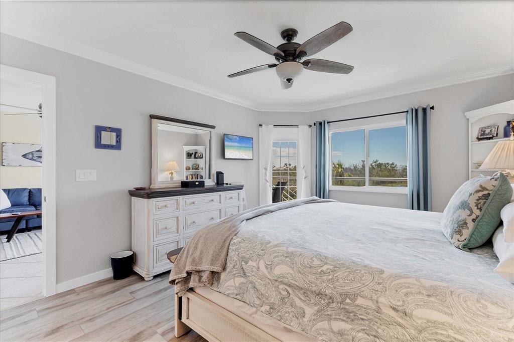 11000 Placida Road, Unit 302 Placida, FL 33946 - Photo 21 of 68 a bedroom with a large bed and a window
