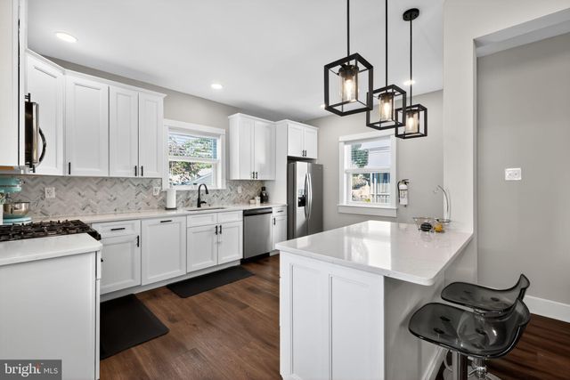 a kitchen with sink cabinets and stainless steel appliances