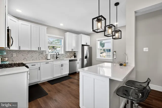a kitchen with sink cabinets and stainless steel appliances
