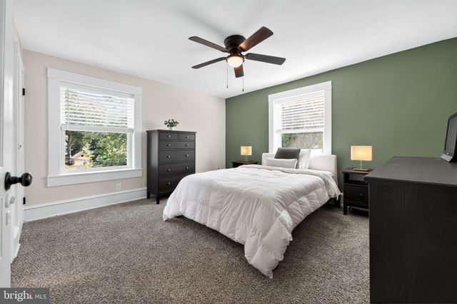 a spacious bedroom with a bed and window