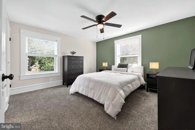 a spacious bedroom with a bed and window