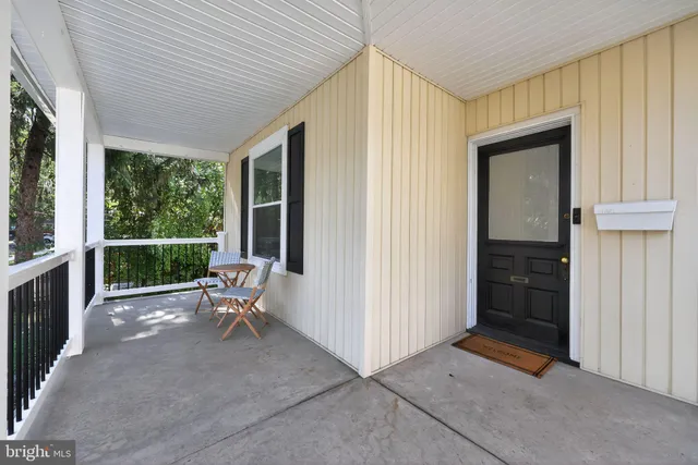 a view of a porch with furniture and garden