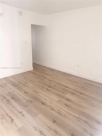 an empty room with wooden floor