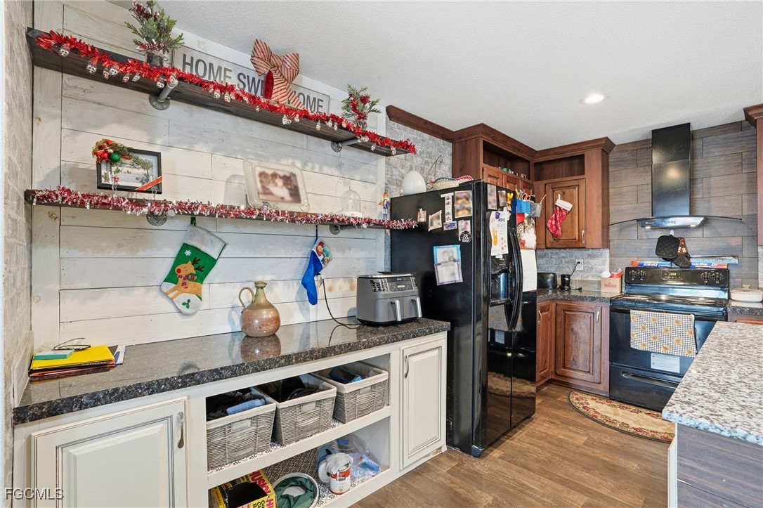 2491 Farrance Court North Fort Myers, FL 33917 - Photo 11 of 26 a kitchen with stainless steel appliances granite countertop a stove and cabinets