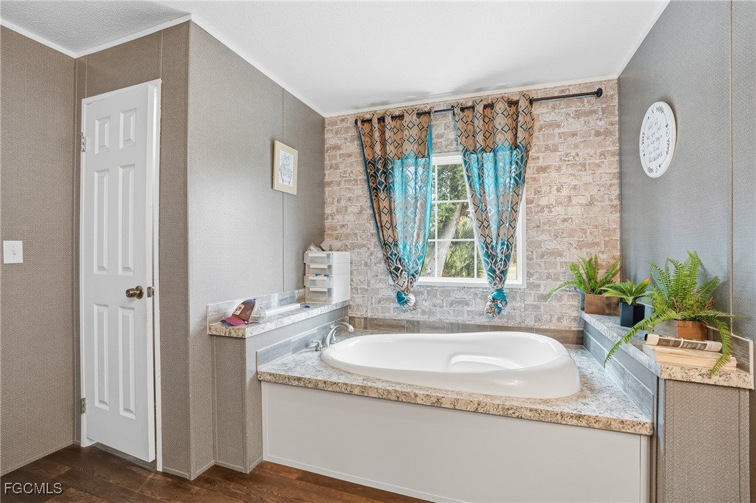 2491 Farrance Court North Fort Myers, FL 33917 - Photo 16 of 26 a bathroom with a granite countertop sink and a mirror