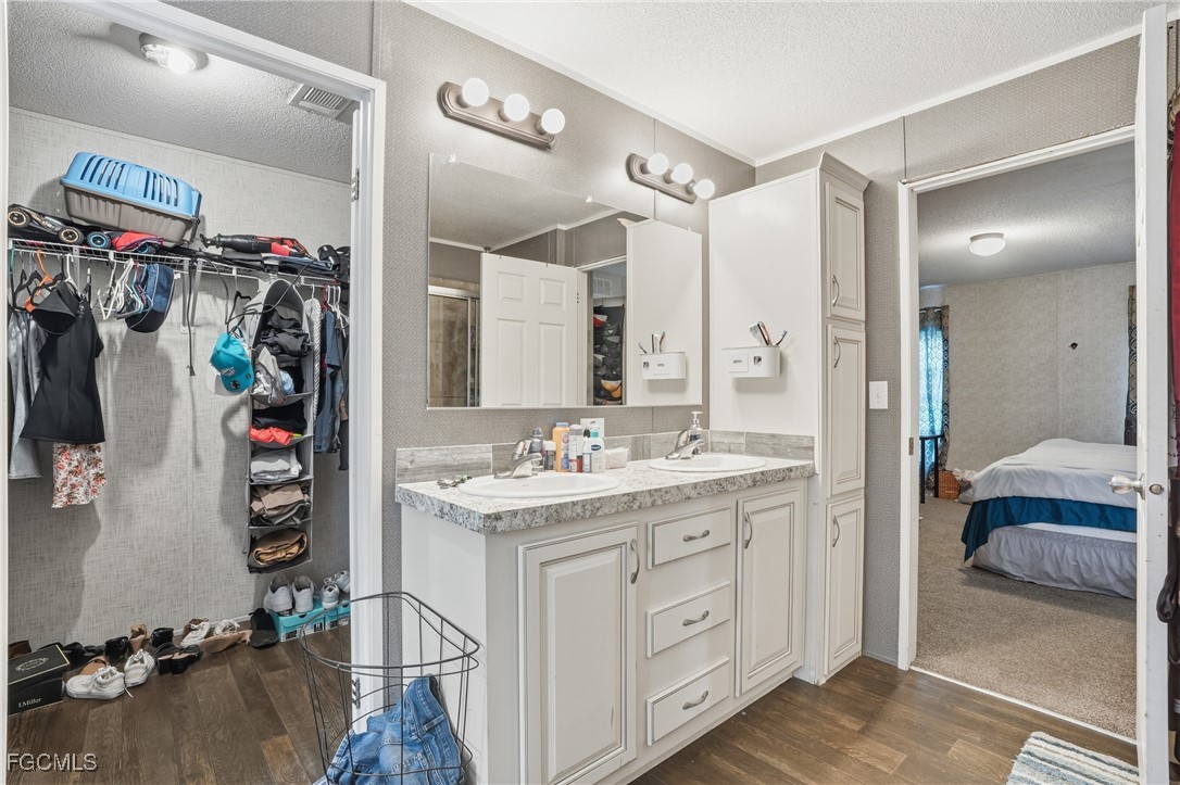 2491 Farrance Court North Fort Myers, FL 33917 - Photo 17 of 26 a en suite bathroom with a double vanity sink and a mirror
