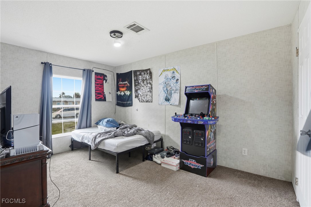 2491 Farrance Court North Fort Myers, FL 33917 - Photo 19 of 26 a living room with furniture and a flat screen tv