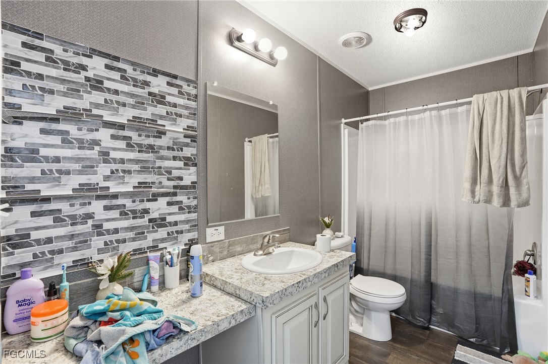 2491 Farrance Court North Fort Myers, FL 33917 - Photo 20 of 26 a bathroom with a granite countertop sink and a toilet