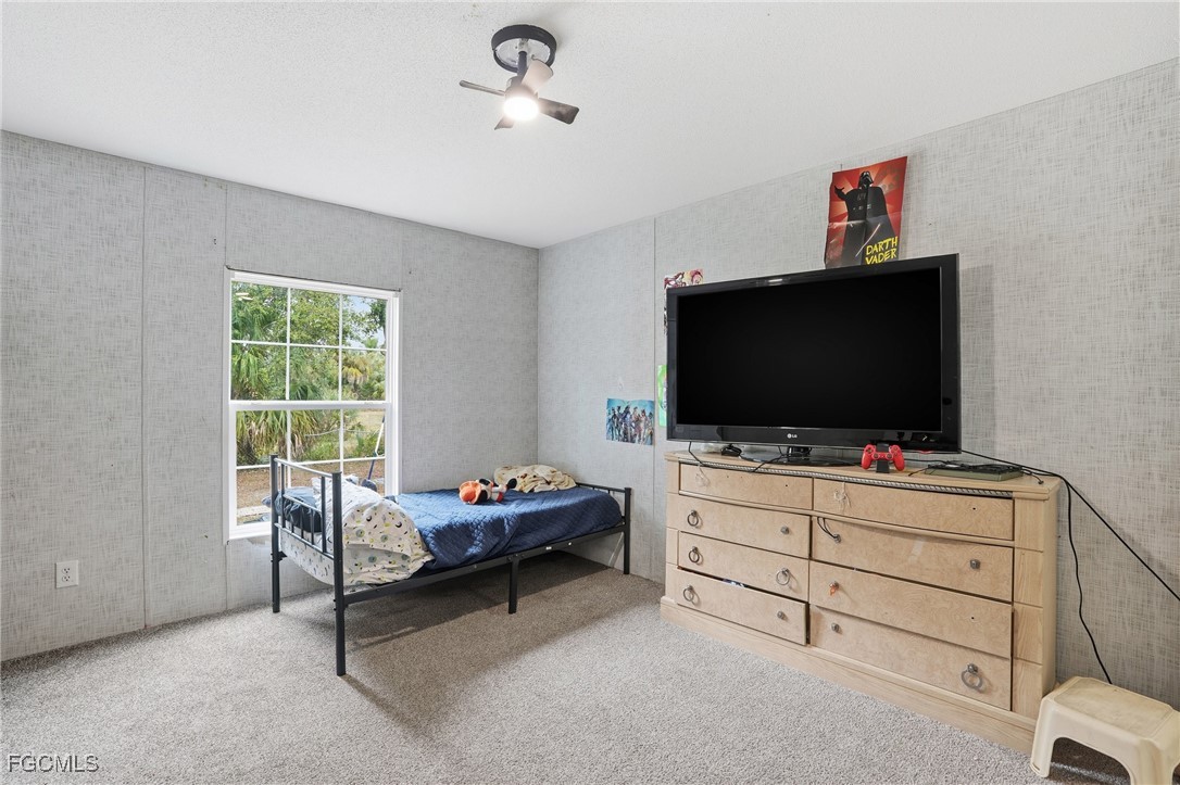 2491 Farrance Court North Fort Myers, FL 33917 - Photo 22 of 26 a living room with furniture and flat screen tv