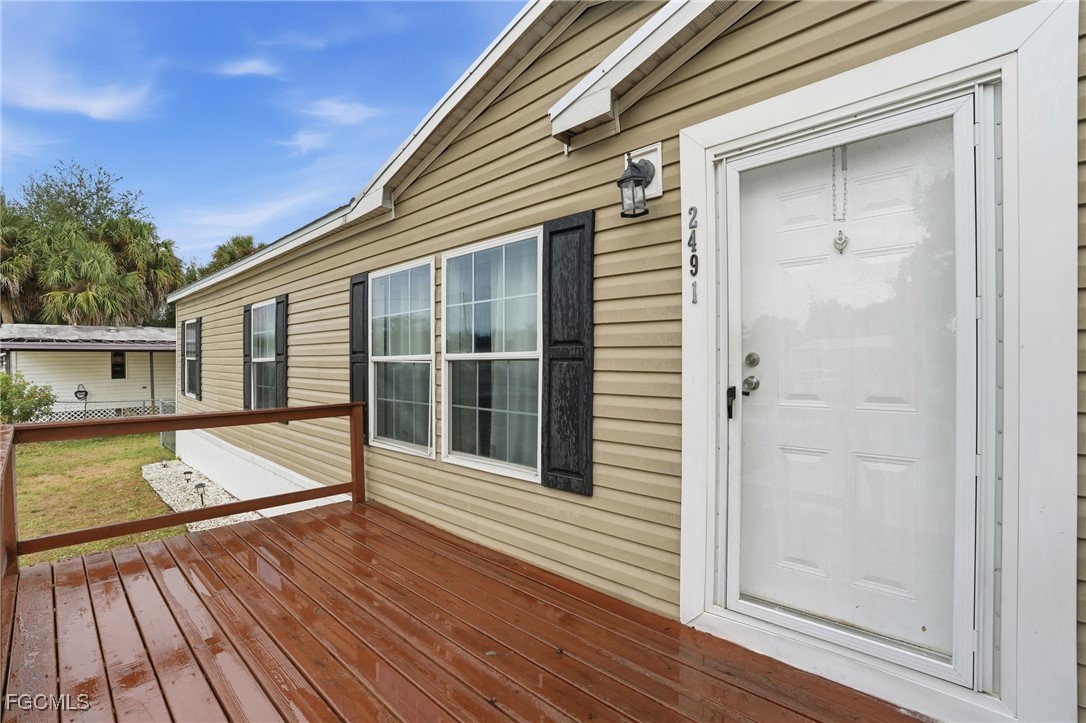 2491 Farrance Court North Fort Myers, FL 33917 - Photo 3 of 26 a view of a house with pool and wooden floor