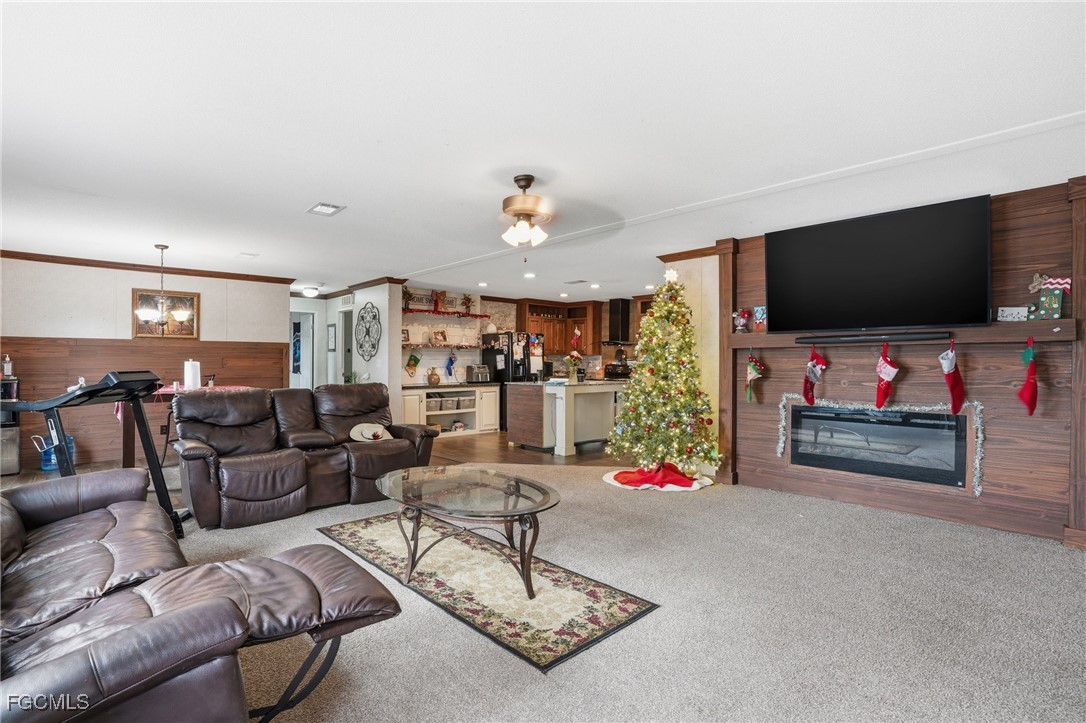 2491 Farrance Court North Fort Myers, FL 33917 - Photo 5 of 26 a living room with furniture and a flat screen tv