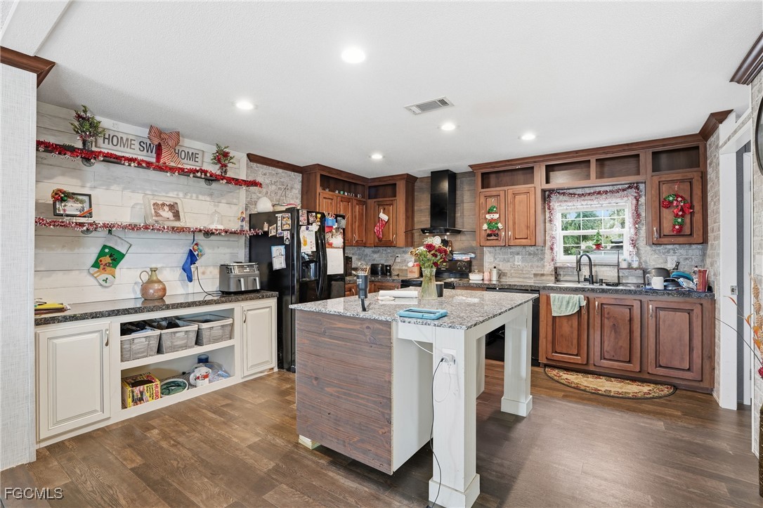 2491 Farrance Court North Fort Myers, FL 33917 - Photo 8 of 26 a kitchen with stainless steel appliances granite countertop a lot of counter space and wooden floors