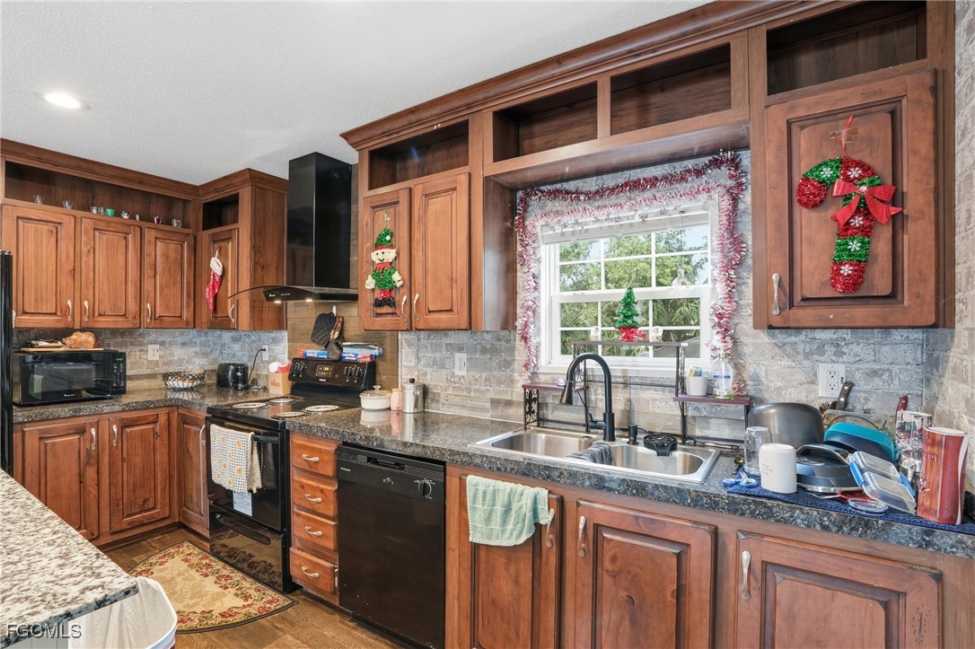 2491 Farrance Court North Fort Myers, FL 33917 - Photo 9 of 26 a kitchen with stainless steel appliances granite countertop a sink stove and cabinets