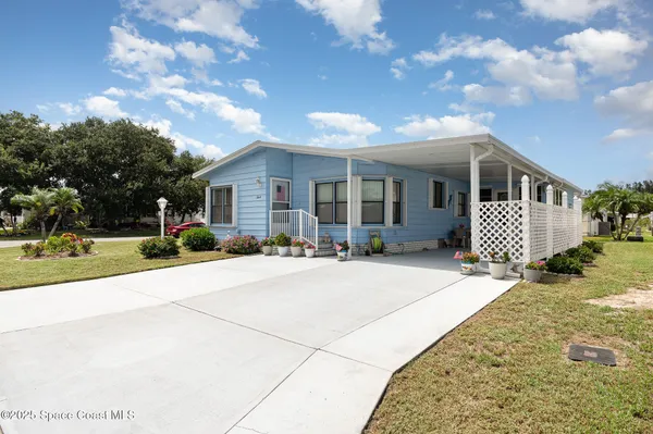a front view of a house with garage and yard