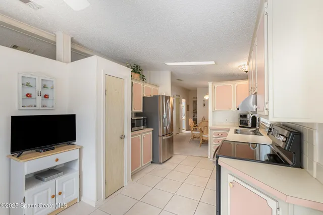 a kitchen with a sink and a stove top oven