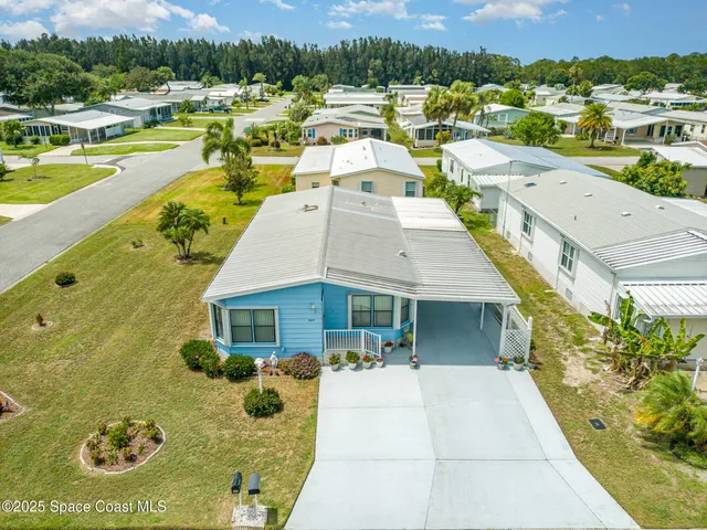 a view of a swimming pool with a patio and a yard