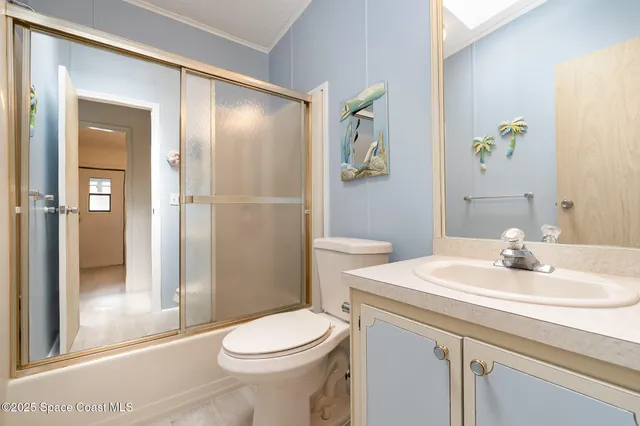 a spacious bedroom with a bed a couch and dresser