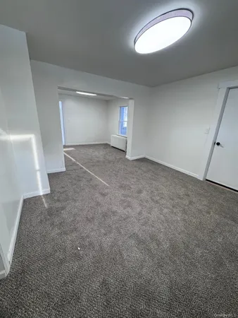 a view of an empty room with a fireplace