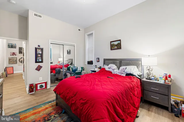 a bed room with a bed and a potted plant