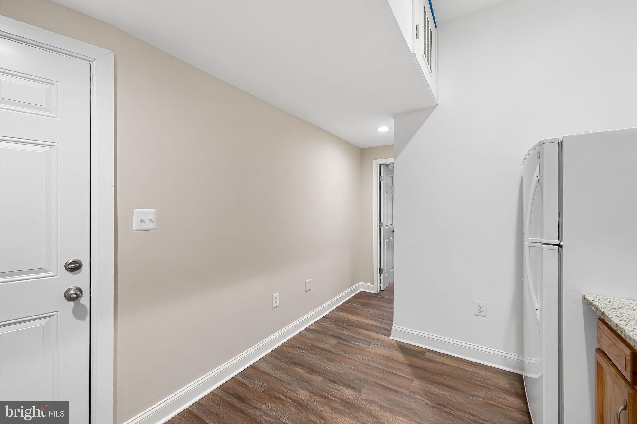 1005 Edmondson Avenue Baltimore, MD 21223 - Photo 23 of 45 a view of a hallway with wooden floor