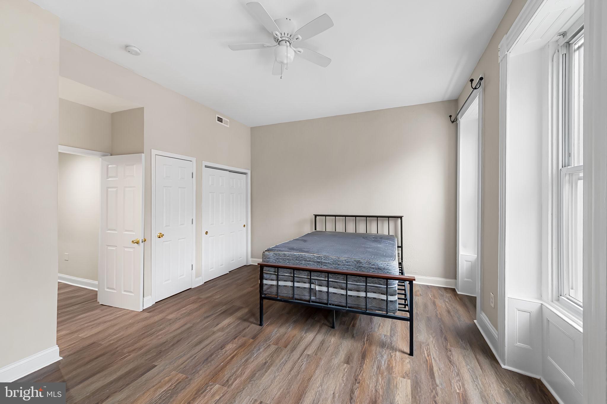 1005 Edmondson Avenue Baltimore, MD 21223 - Photo 26 of 45 a view of a room with wooden floor staircase and windows