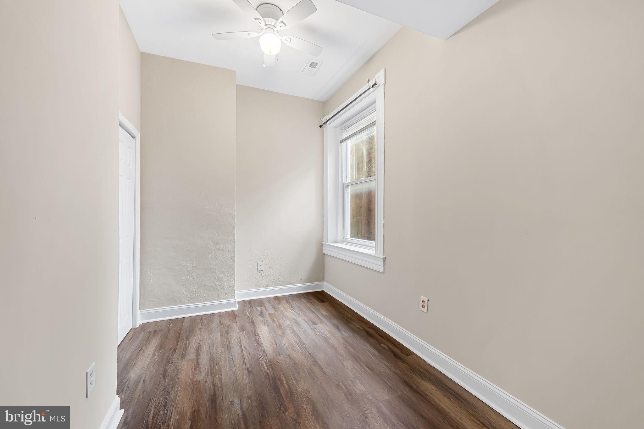 1005 Edmondson Avenue Baltimore, MD 21223 - Photo 28 of 45 wooden floor in an empty room with a window