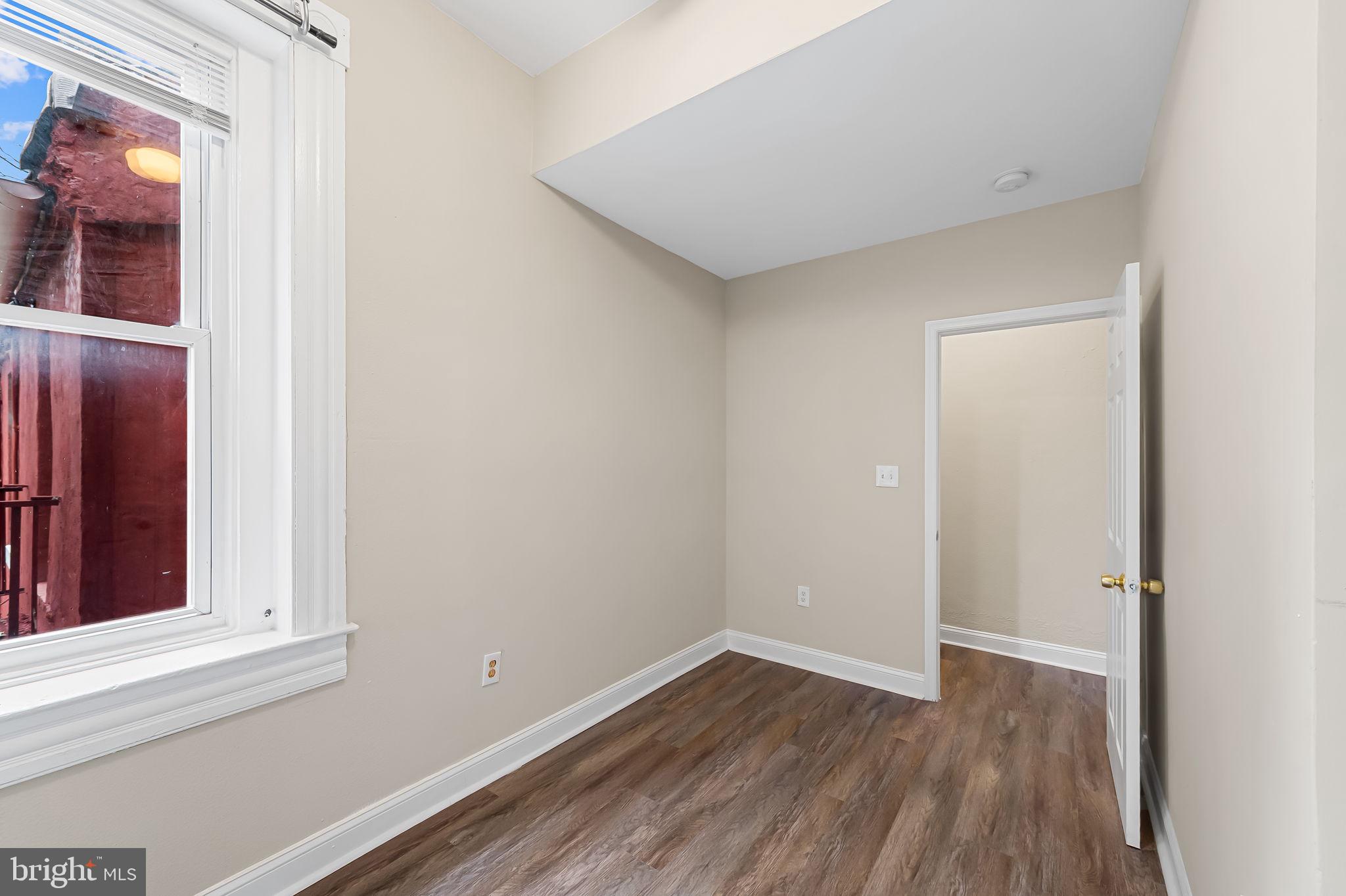 1005 Edmondson Avenue Baltimore, MD 21223 - Photo 29 of 45 a view of a small space with wooden floor and a window