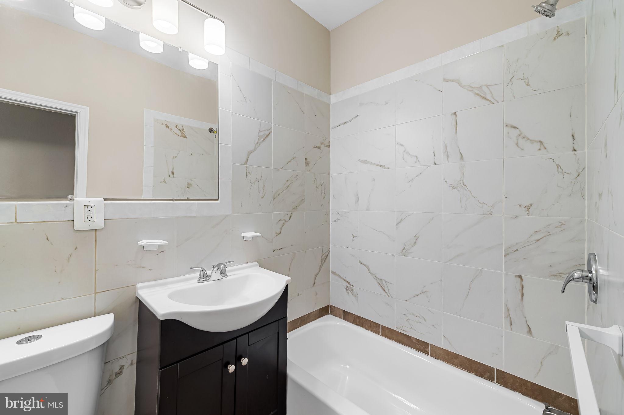 1005 Edmondson Avenue Baltimore, MD 21223 - Photo 30 of 45 a bathroom with a sink a toilet and bathtub