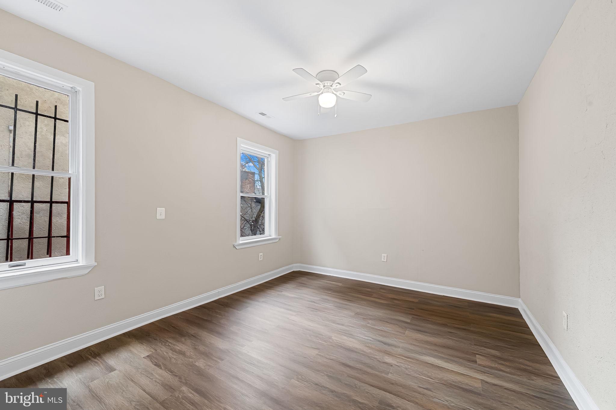 1005 Edmondson Avenue Baltimore, MD 21223 - Photo 31 of 45 a view of an empty room with wooden floor and a window