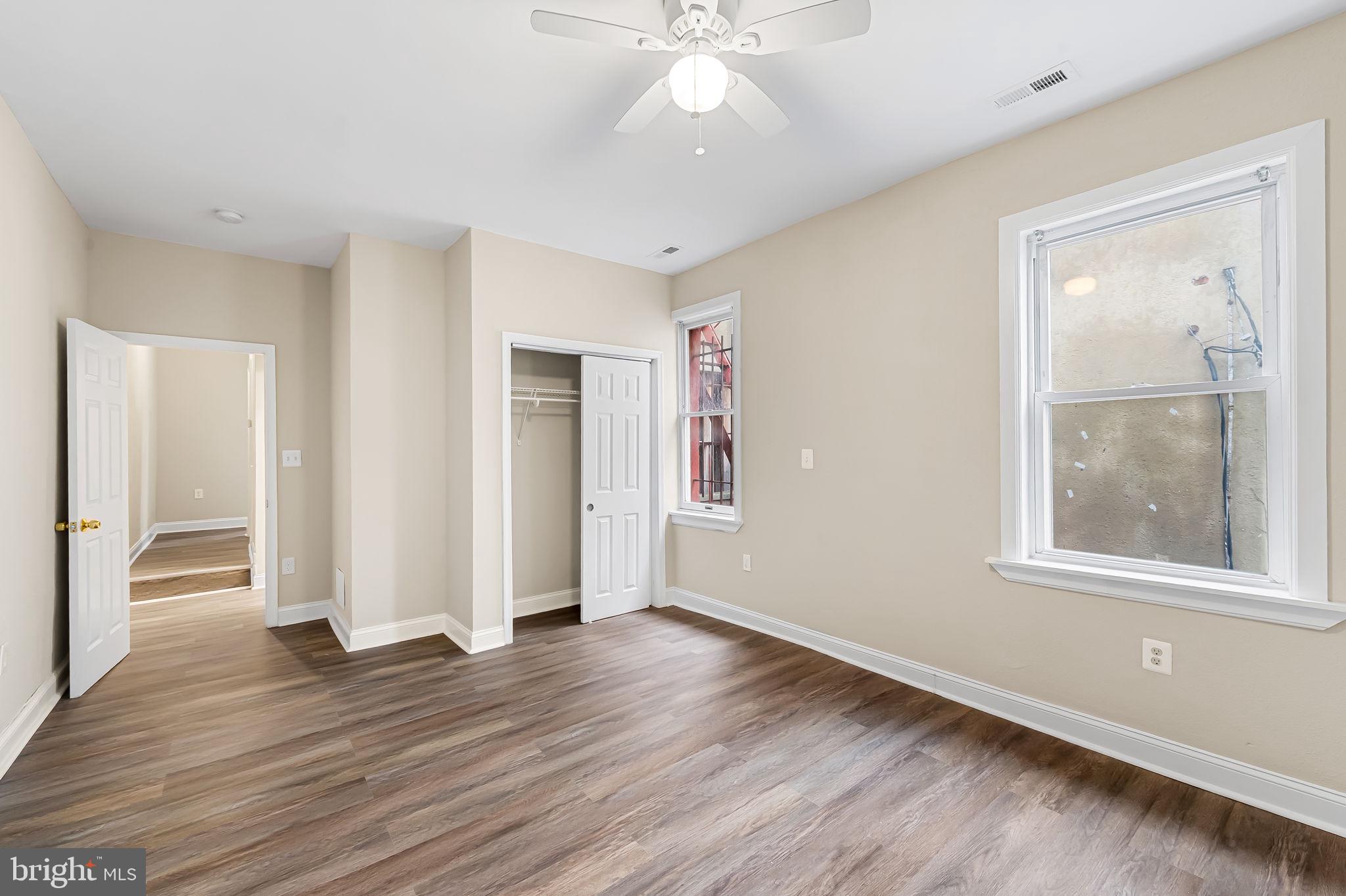 1005 Edmondson Avenue Baltimore, MD 21223 - Photo 32 of 45 an empty room with wooden floor and windows