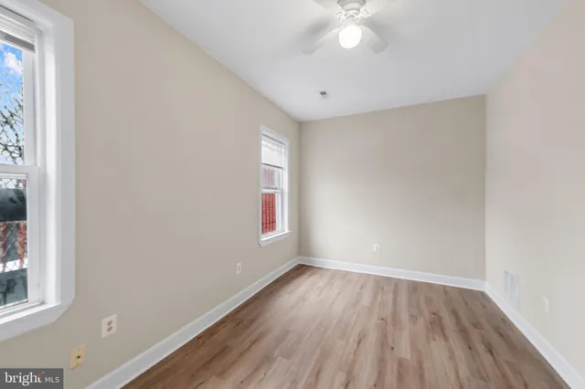 wooden floor in an empty room with a window