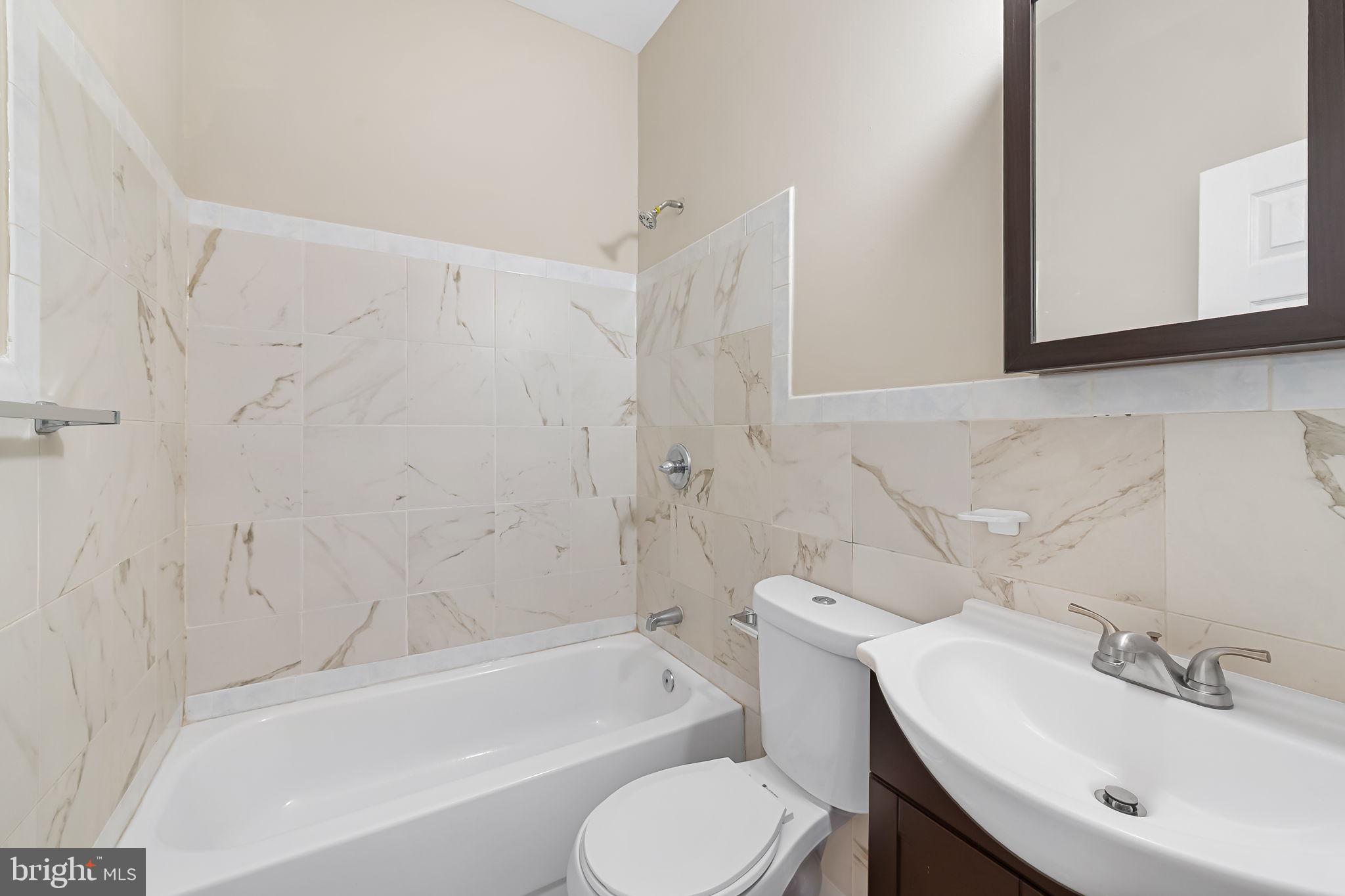 1005 Edmondson Avenue Baltimore, MD 21223 - Photo 40 of 45 a bathroom with a sink toilet and bathtub