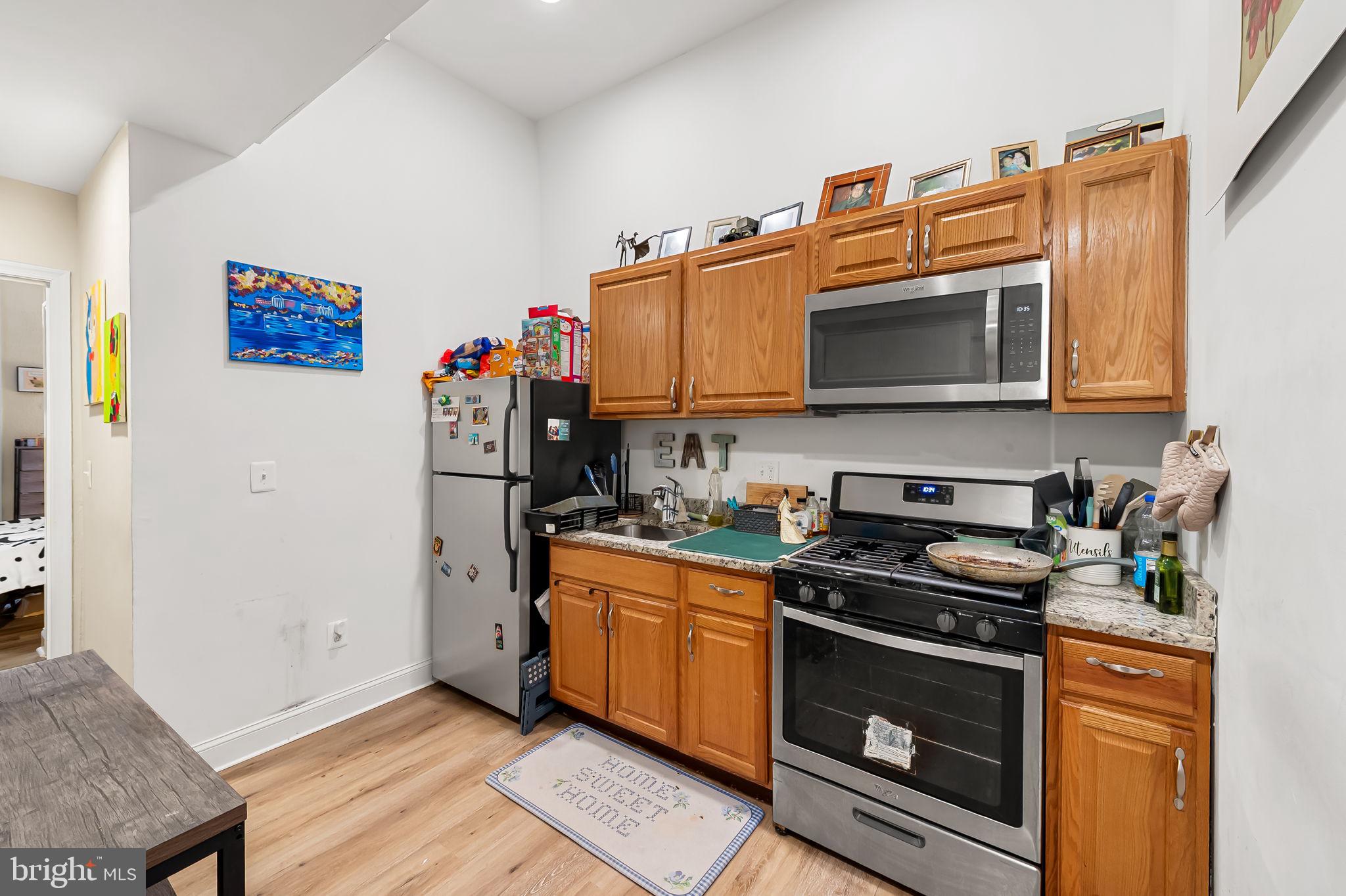 1005 Edmondson Avenue Baltimore, MD 21223 - Photo 4 of 45 a kitchen with stainless steel appliances granite countertop a stove and a microwave