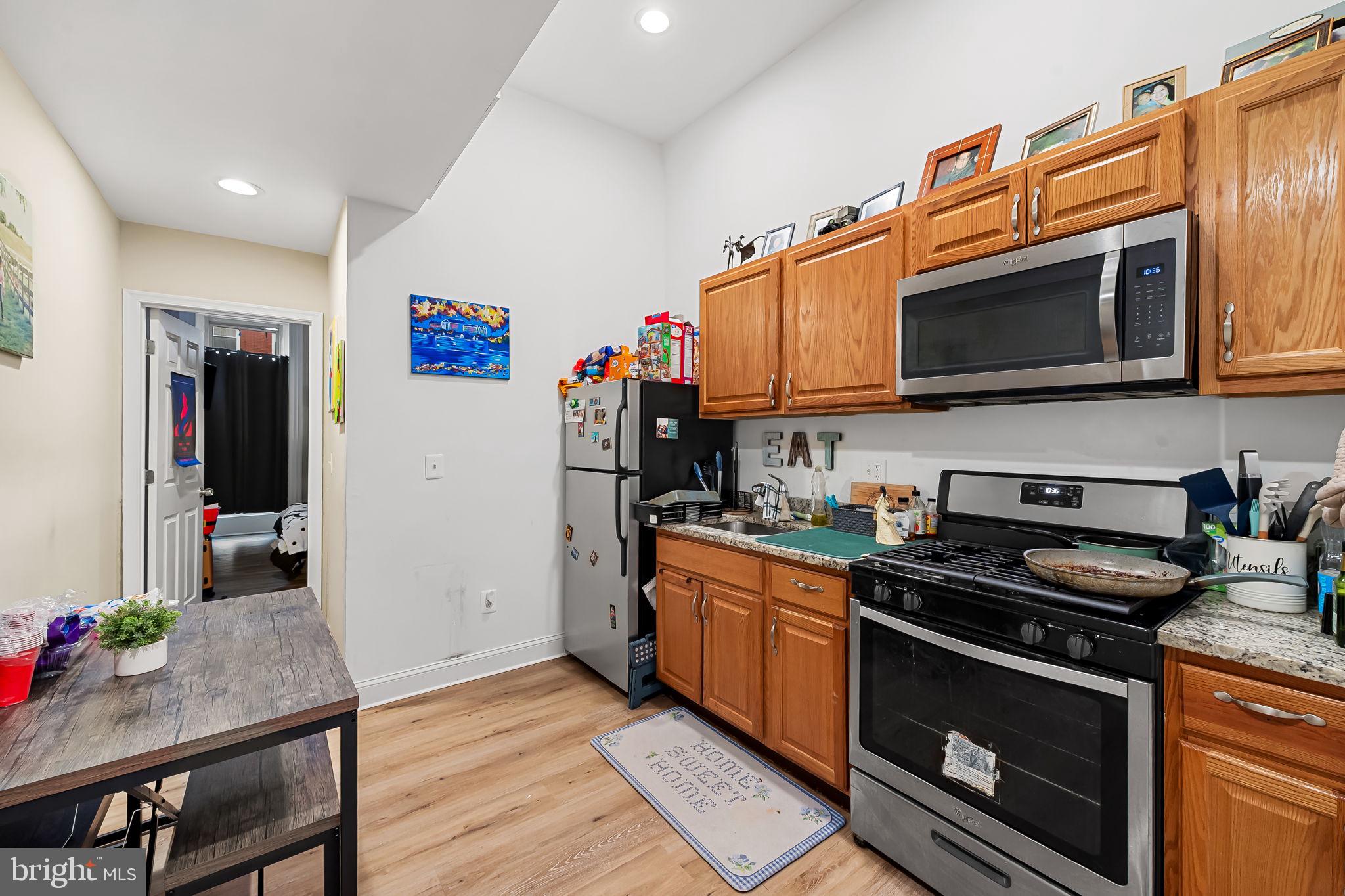 1005 Edmondson Avenue Baltimore, MD 21223 - Photo 6 of 45 a kitchen with stainless steel appliances granite countertop a stove a sink and a microwave