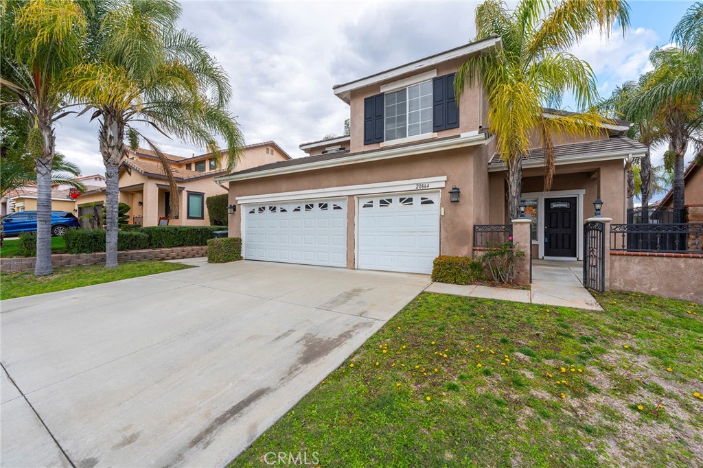 20864 Millbrook Street Riverside, CA 92508 - Photo 1 of 1 a front view of a house with a yard and garage