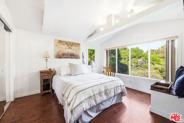 a bedroom with a large bed and a large window