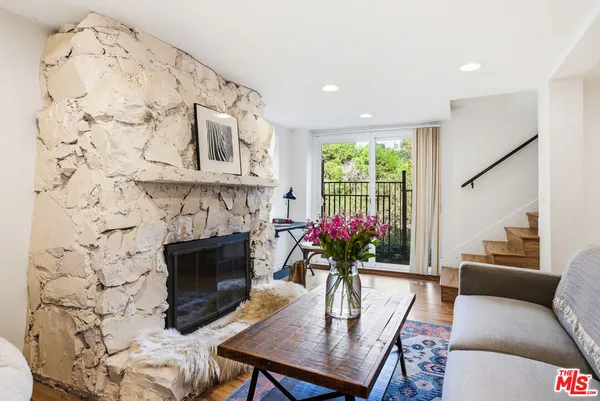 a dining room with furniture a fireplace and a chandelier