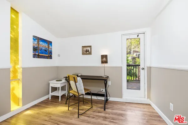a view of a livingroom with furniture and a window