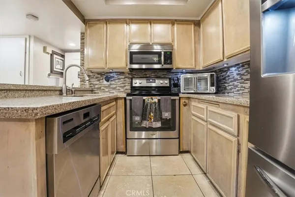 a view of a kitchen with a sink and cabinets
