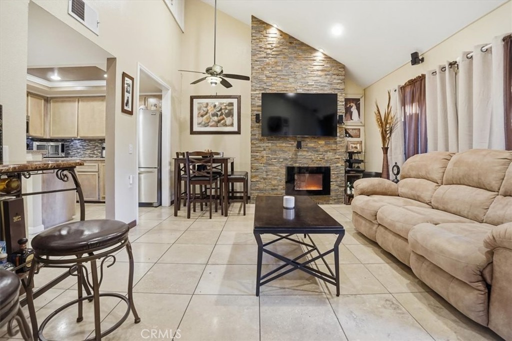 300 South Prospectors Road, Unit 29 Diamond Bar, CA 91765 - Photo 13 of 37 a living room with furniture a flat screen tv and kitchen view