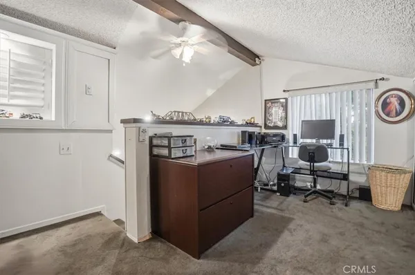a bedroom with bed and a tv