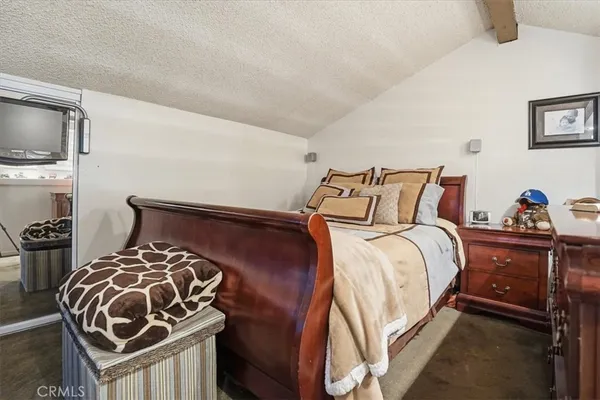 a bed room with a bed and a television