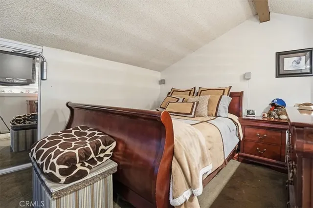 a bed room with a bed and a television