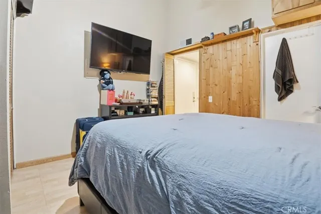 a bedroom with a bed and a closet