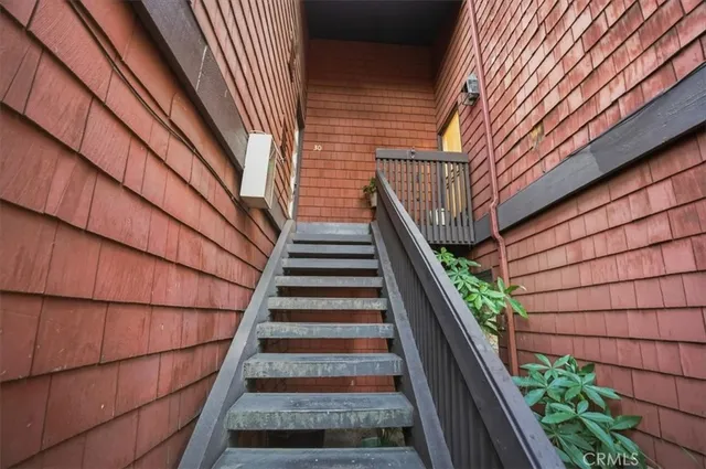 a view of entryway with wooden floor and front door